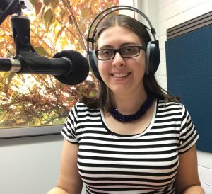 Young woman wearing headphones in a radio studio